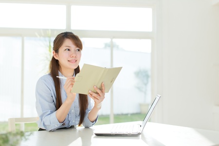 Beautiful asian businesswoman using a laptop computerの写真素材