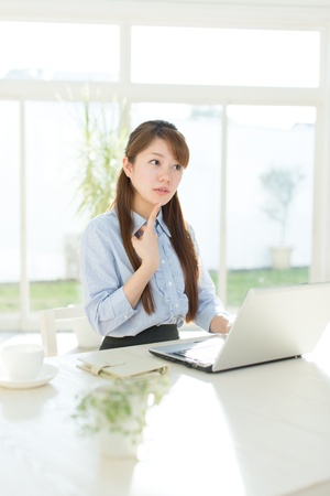 Beautiful asian businesswoman using a laptop computerの写真素材