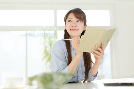 Beautiful asian businesswoman using a laptop computerの写真素材