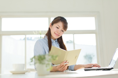 Beautiful asian businesswoman using a laptop computerの写真素材