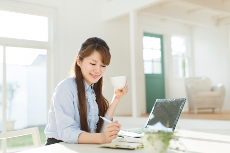 Beautiful asian businesswoman using a laptop computerの写真素材