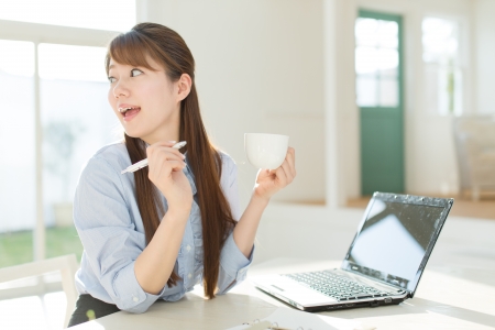 Beautiful asian businesswoman using a laptop computerの写真素材