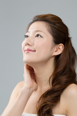 Beautiful asian woman on gray backgroundの写真素材
