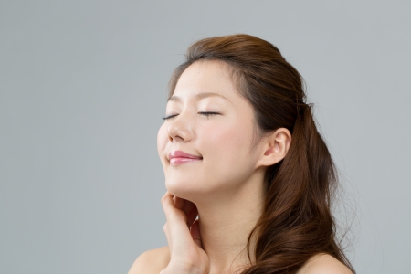 Beautiful asian woman on gray backgroundの写真素材