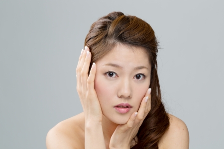 Beautiful asian woman on gray backgroundの写真素材
