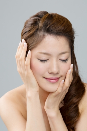 Beautiful asian woman on gray backgroundの写真素材