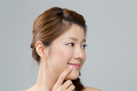 Beautiful asian woman on gray backgroundの写真素材