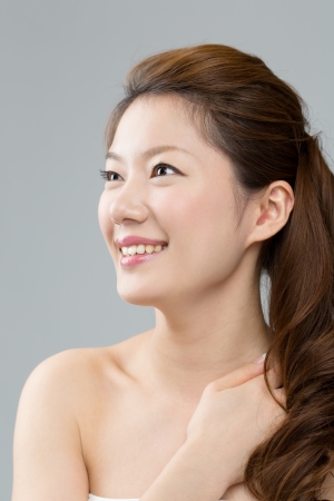 Beautiful asian woman on gray backgroundの写真素材