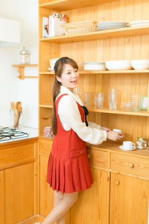Beautiful young woman in the kitchenの写真素材