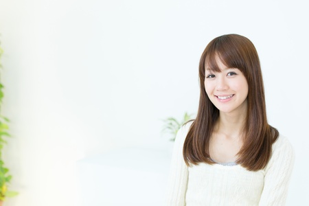 Beautiful asian woman relaxing in the roomの写真素材