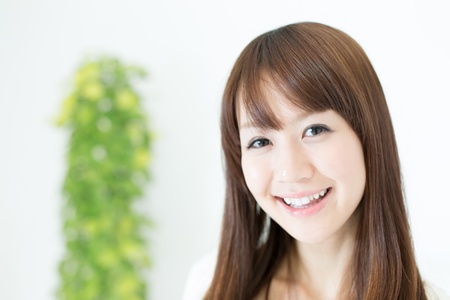 Beautiful asian woman relaxing in the roomの写真素材