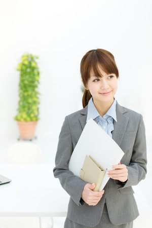 Beautiful young businesswoman working in office の写真素材