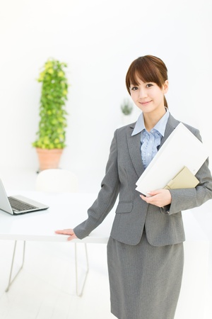 Beautiful young businesswoman working in office の写真素材