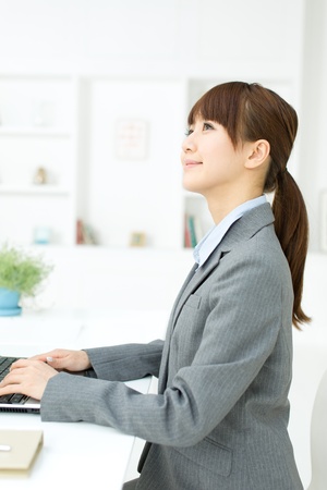 Beautiful young businesswoman working in office の写真素材