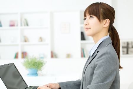 Beautiful young businesswoman working in office の写真素材