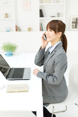 Beautiful young businesswoman working in office の写真素材