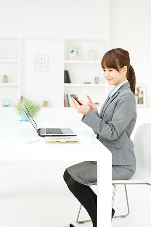 Beautiful young businesswoman working in office の写真素材