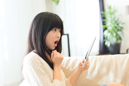 Beautiful asian woman relaxing in the roomの写真素材