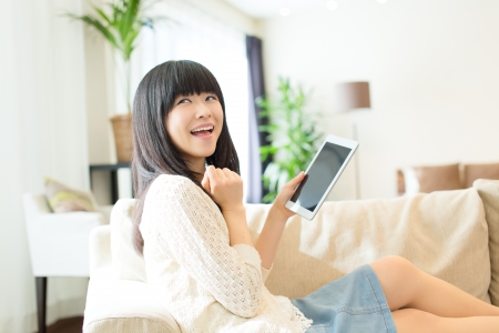 Beautiful asian woman relaxing in the roomの写真素材