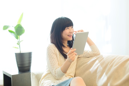 Beautiful asian woman relaxing in the roomの写真素材