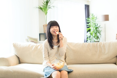 Beautiful asian woman relaxing in the roomの写真素材