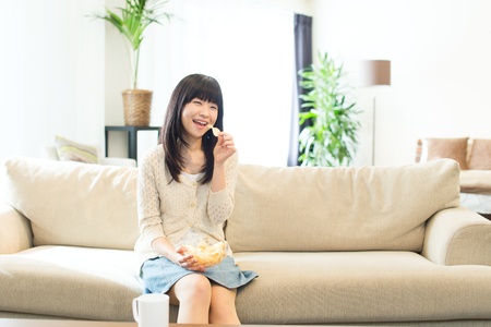 Beautiful asian woman relaxing in the roomの写真素材
