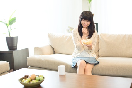 Beautiful asian woman relaxing in the roomの写真素材