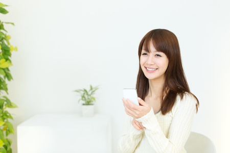 Beautiful young woman using a cellular phoneの写真素材