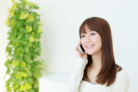 Beautiful young woman using a cellular phoneの写真素材