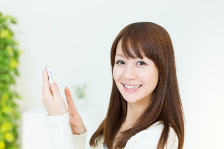 Beautiful young woman using a cellular phoneの写真素材