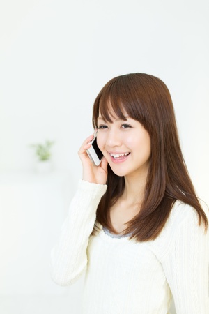 Beautiful young woman using a cellular phoneの写真素材