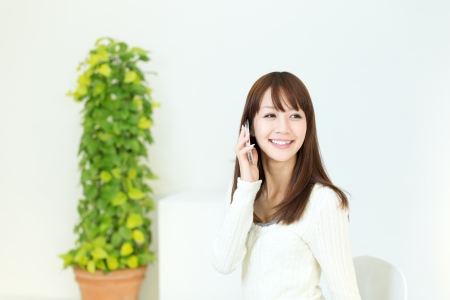Beautiful young woman using a cellular phoneの写真素材