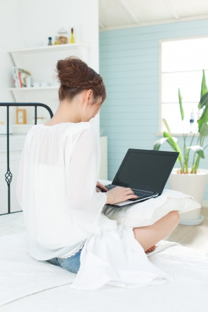 Beautiful asian woman relaxing in the roomの写真素材