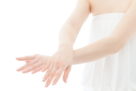 Beautiful young woman hands on white backgroundの写真素材