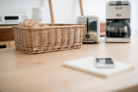 Fresh french bread in basket over wooden table with copy spaceの写真素材