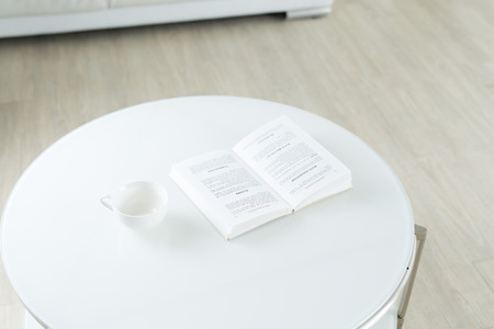 Books and coffee cup on tableの写真素材