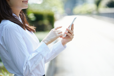 business woman with smart phone on handの写真素材