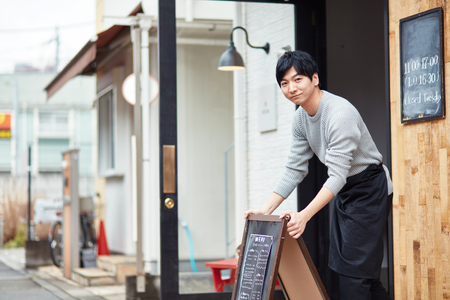 Portrait of a young man working of coffee shopの写真素材