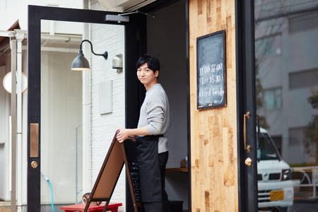 Portrait of a young man working of coffee shopの写真素材