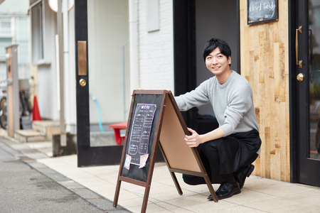 Portrait of a young man working of coffee shopの写真素材