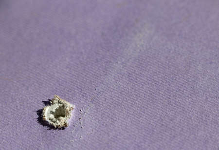 Hole in drywall left by screw or nailの写真素材