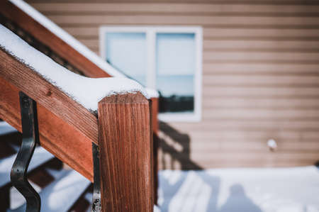Snow covered wooden steps on a residential houseの写真素材
