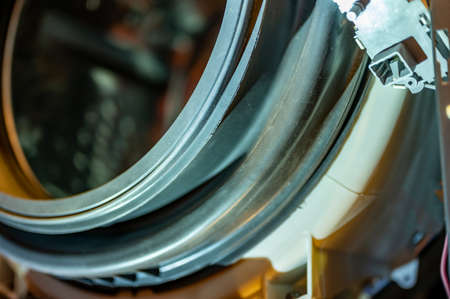 Selective Focus on the gasket mount of a front loading washing machine being servicedの写真素材
