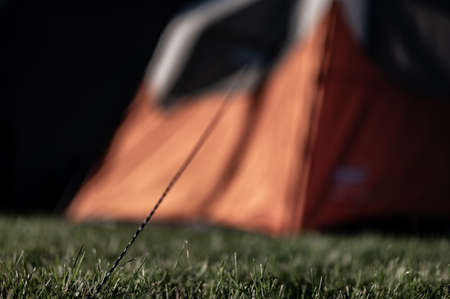 Selective focus on tent support rope leading up to the canvas to secure in-placeの写真素材