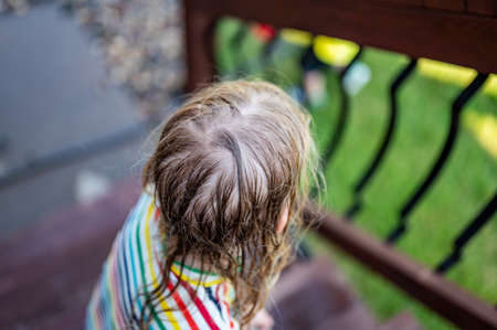 Focus on wet tangled hair of a young girl outdoorsの写真素材