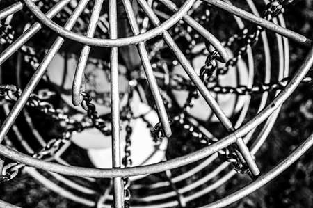 Top view of a golf basket chains with discs blurred belowの写真素材