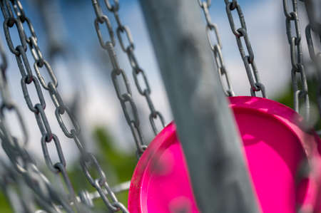 Different angles of view of a disc golf basket and chainsの写真素材
