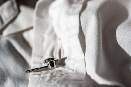 button extender shown on a white dress shirt to increase size