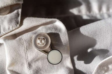 button extender shown on a white dress shirt to increase sizeの写真素材