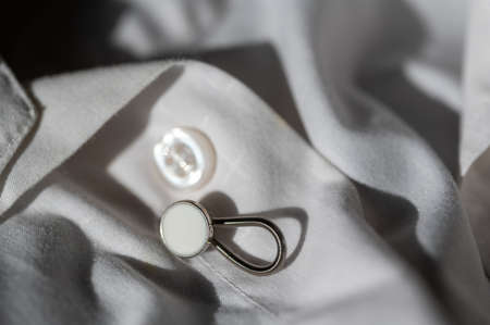 button extender shown on a white dress shirt to increase sizeの写真素材